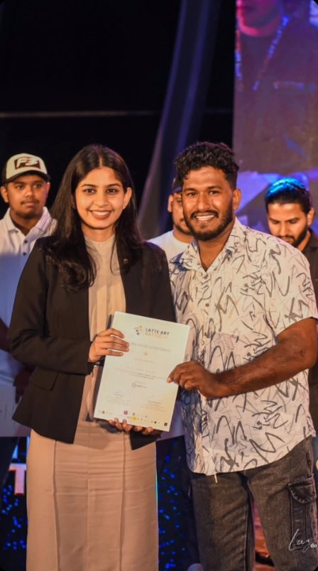 Barista Asi receiving his Latte Art Battle certificate